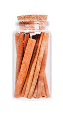 Cinnamon in a glass bottle with cork stopper, isolated on white.