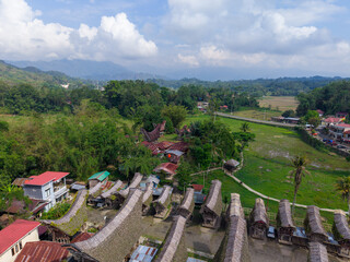 Aerial view of the traditional Tongkonan houses in Ke&rsquo;te Kesu village, Tana Toraja, Indonesia, surrounded by lush green rice fields.  
