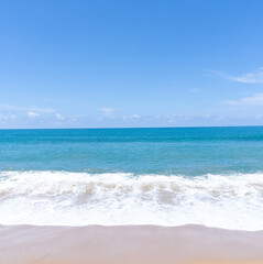 Deep blue sea with whitecap of wave into the coast and blue sky whit thin fluffy clouds in the distance taken at the sea in Phuket South of Thailand used as blue natural background texture