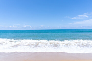 Deep blue sea with whitecap of wave into the coast and blue sky whit thin fluffy clouds in the distance taken at the sea in Phuket South of Thailand used as blue natural background texture