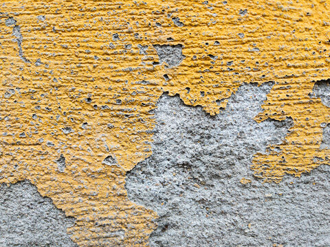 Yellow cracked wall with peeling paint texture