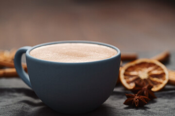 Hot chocolate in a blue cup with natural christmas decorations