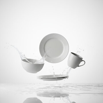 Dishes white bowl and plates and spoon levitating