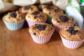 Delicious Chocolate Muffins in Colorful Liners on Wooden Table, Freshly Baked Treats for Shared Moments