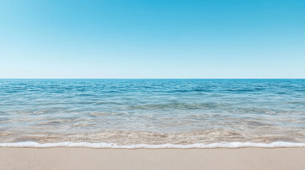 Fototapeta premium Calm seascape with clear blue sky and gentle waves lapping on sandy beach