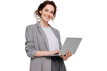 Confident young woman with curly hair smiles at camera while using a laptop demonstrating modern workstyle and portraying positive energy in the digital age for successful online