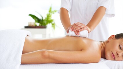 Fototapeta premium Relaxing massage therapy session with a woman enjoying a soothing treatment
