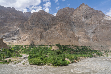 Scenic mountain landscape view of remote rural afghan village in Panj river valley in summer, Rushan, Gorno-Badakhshan, Tajikistan Pamir