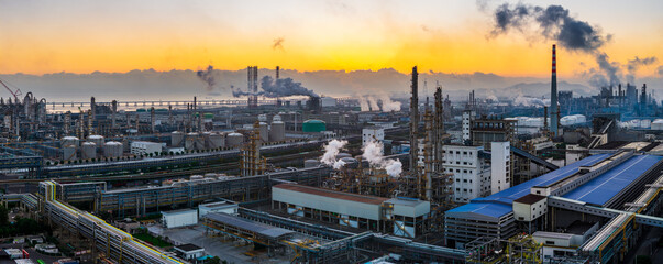 Aerial view of oil refinery and chemical plant with pipeline equipment in a large industrial area at sunrise