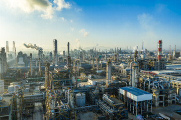 Aerial view of oil refinery and chemical plant with pipeline equipment in a large industrial area at sunrise