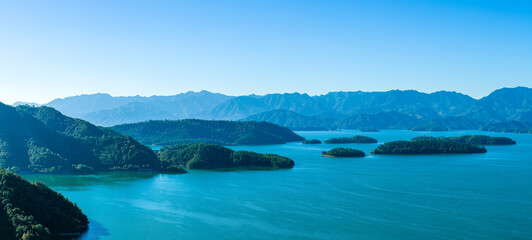 Beautiful natural landscape of a large lake with green islands and mountain in Hangzhou