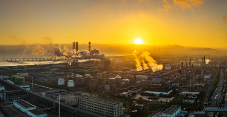 Aerial view of oil refinery and chemical plant with pipeline equipment in a large industrial area at sunrise