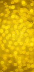 Abstract image of yellow-gold swirled bokeh background. Vertical 19:9 format.