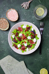 Salad with figs, feta cheese, pomegranate, and pecans. Healthy eating. Vegetarian food.