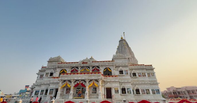 Beautiful frontal view of the white marble Prem Mandir temple in Vrindavan, India, under a clear blue sky. The temple&rsquo;s intricate carvings and spiritual ambiance represent devotion and peace in Hindu 