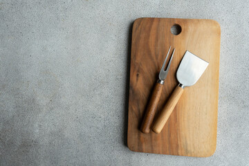 Cutting board with cheese knives