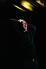 Excited actor touching head on theater scene 