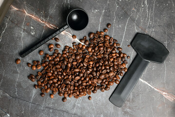 Coffee press with hot coffee and roasted beans on a dark background