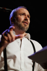Portrait of actor gesturing during rehearsal in theater 
