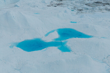 A stunning and surreal landscape unfolds in Greenland's UNESCO World Heritage Ilulissat Icefjord. Massive icebergs, freshly calved from the Sermeq Kujalleq glacier