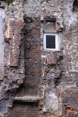 Old Window in Brick Wall
Weathered window framed by aged, cracked, and neglected bricks.
