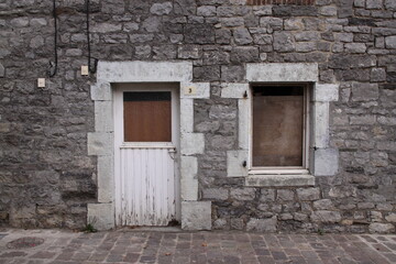Old Window in Brick Wall
Weathered window framed by aged, cracked, and neglected bricks.
