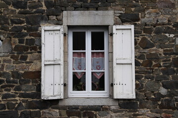 Old Window in Brick Wall
Weathered window framed by aged, cracked, and neglected bricks.
