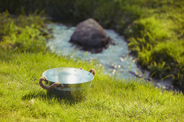 Old wash basin in the yard by the stream
