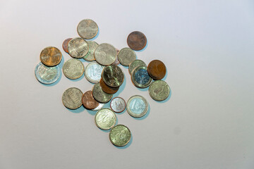 A pile of old coins with a silver and gold color