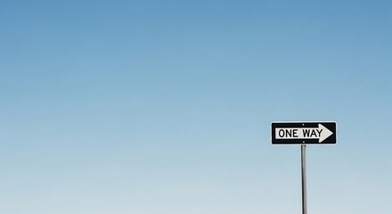 A one way street sign with a right pointing arrow against a clear blue sky, a powerful metaphor for guidance, decision, and a singular path forward