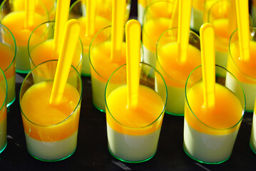 Two-layer jelly with creamy orange flavor in cups. Concept of Christmas treat, dietary holiday desserts, low-calorie sweets, healthy eating, catering for seasonal celebrations, and mindful indulgence.