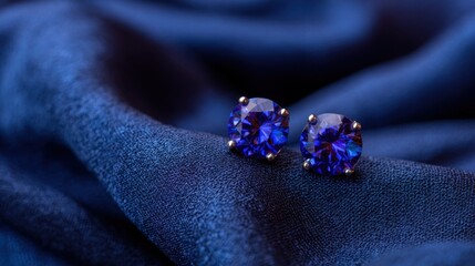 Elegant Sapphire Earrings on Soft Blue Fabric with Luxurious Texture and Subtle Shine