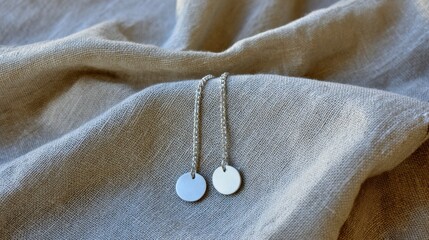 Elegant Silver Drop Earrings on Soft Fabric Background Showcasing Minimalist Jewelry Design for Modern Accessories Lovers