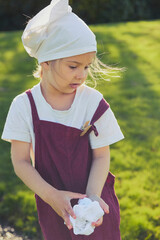 Charming girl washing clothes in the garden. Retro portrait