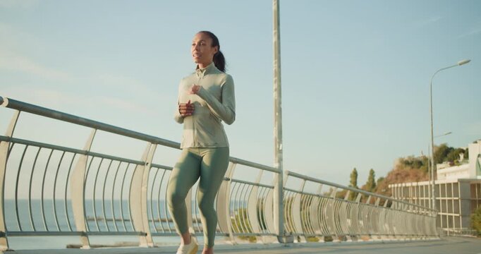 Embracing a Healthy Lifestyle A Woman is Running Along a Scenic Pathway by the Beautiful Sea - Powered by Adobe