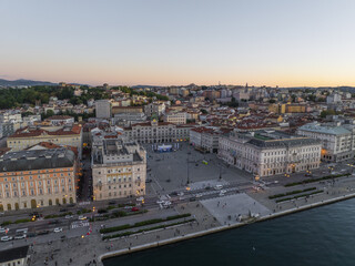 Aerial view of the expansive Piazza UnitÃ  d'Italia meeting the Adriatic Sea, with the Government Palace casting long shadows in the soft evening light, Trieste, Friuli-Venezia Giulia, Italy.