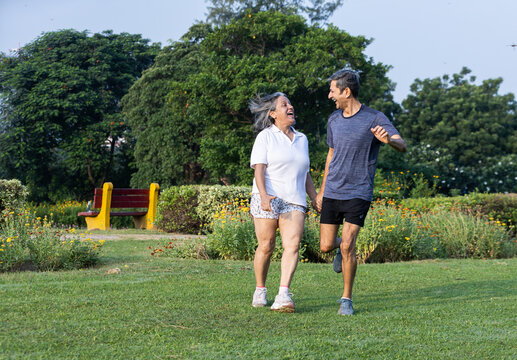 Happy Senior Couple Jumping with Joy in Park, Embracing Active Healthy Lifestyle Together