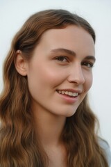 Naklejka premium Close-up portrait of a happy young woman with natural beauty. Model with healthy clean skin and a perfect smile. Skincare and dermatology concept