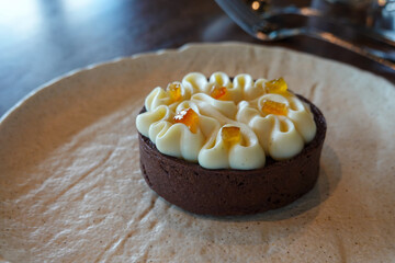 Mini tart topped with piped cream rosettes
