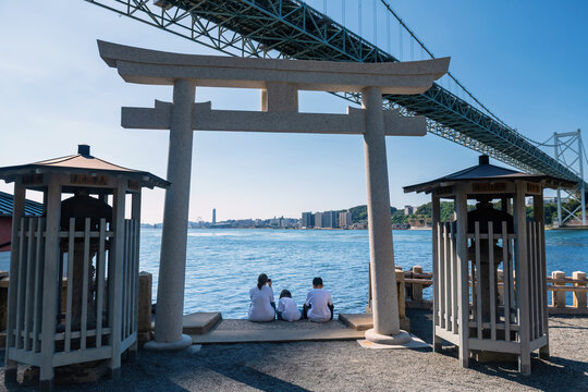 Family at Torii gate of Mekari Shrine by Kanmon bridge, Kitakyushu