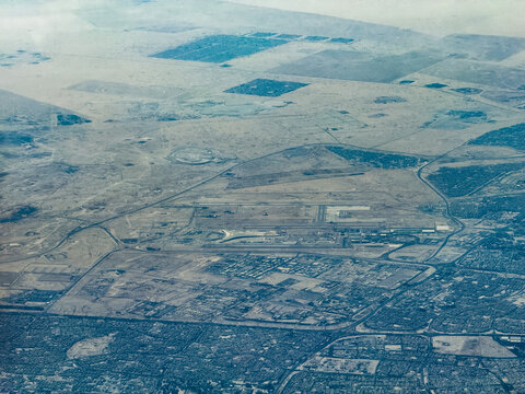 aerial landscape view of area around Kuwait International Airport (IATA: KWI, ICAO: OKKK)  with runways, taxiways, terminals, hangars and other infrastructure, located in the State of Kuwait