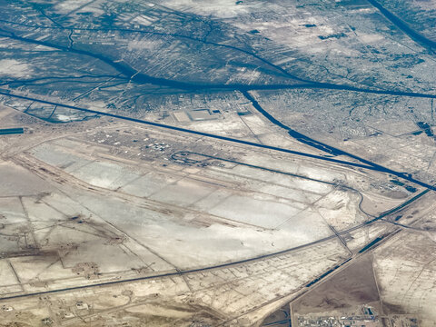 aerial landscape view of area around Basra International Airport (IATA: BSR, ICAO: ORMM) located west of Basra city, next to Basra Canal and Abdullah Canal