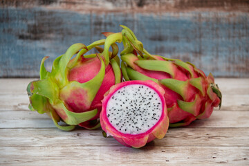 Dragon fruit pitaya whole and sliced on wood