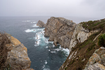 Lighthouse of Peña seascape on a rainy day. Gozón. Asturias. Spain