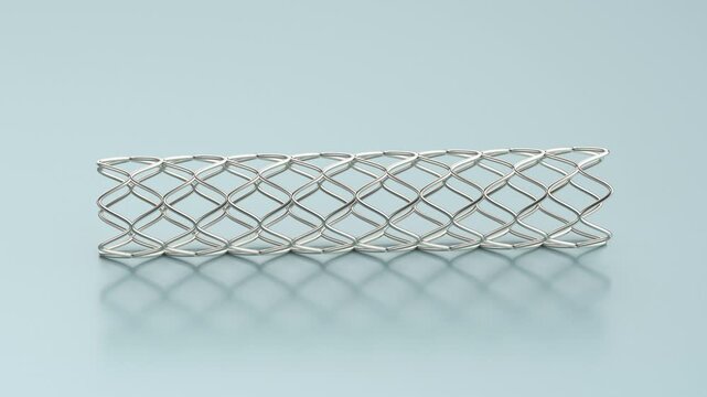 Close-up of medical stent on light blue background