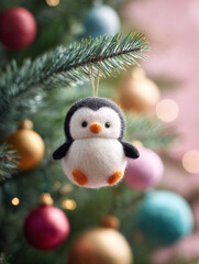 Obraz premium Cute felt penguin ornament hangs on a Christmas tree amongst colorful baubles. Festive, charming, and handcrafted. Perfect for holiday themes, gifts, or whimsical designs.