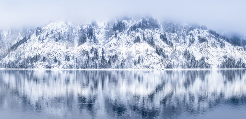 A tranquil winter landscape with snowcovered mountains and seren