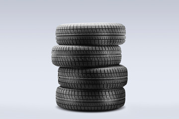 Four winter tires are stacked together, ready for off-season storage. These tires feature velcro and are designed for optimal friction in cold conditions. © Vladimir Razgulyaev