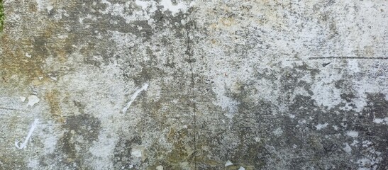 Grungy weathered white concrete wall with dark stains