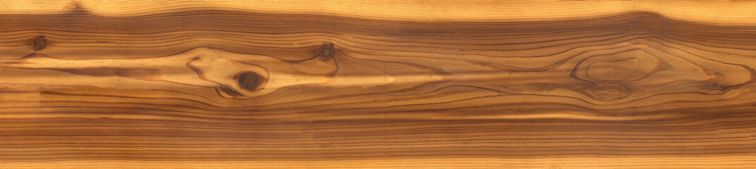 close-up of a brown wood texture with a visible grain pattern and several knots.natural wood plank or a surface, with a warm, reddish-brown hue.